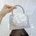 Silver rhinestone evening bag featuring a large white 3D flower and top handle - Silver