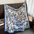 Detailed close-up of blue butterfly floral print on large white square silk scarf - Navy Blue