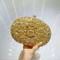 Golden clutch bag featuring rhinestones and amber crystal accents for evening gala - Gold