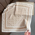 Detailed view of 70cm geometric silk-like scarf with canning pattern on a leather background - 70x70cm / Khaki