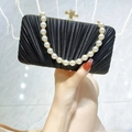 Elegant black pleated evening clutch bag with gold bow clasp and white pearl handle - Black With Rhinestone Pearl Chain