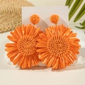 Handmade woven raffia sunflower drop earrings in vibrant orange for beach vacation - Vibrant Orange