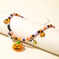 Close-up of Halloween beaded necklace with pumpkin and ghost charms on a scroll - Black Orange Purple Matte Beaded Necklace (30508-nek-colour)