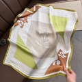 Detail of silk square scarf featuring lime green color blocks and floral line art design - Green