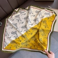 Detail of vibrant color-block floral silk scarf with elegant green contrast border - 70x70cm / Yellow