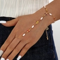 Elegant gold butterfly and pearl finger bracelet jewelry worn by a female model - Colorful Butterfly and Pearl Style (30410-bra-G-1)