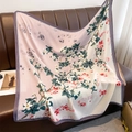 Large floral silk scarf with pink gradient and magnolia print draped on a leather sofa - 90*90cm / Rice Pink