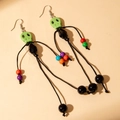 Handmade Halloween tassel earrings with green skull beads and multi-color beaded accents - Green
