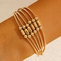 Chic multi-layer gold wire wrap bracelets featuring metallic beads and hexagonal prisms - Multilayer Coil Style (30454 -bra-G) / Gold