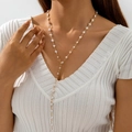 Close-up of a layered golden Y-necklace with small white pearls on a model wearing V-neck - Gold Pearl Y-Shape (28772-nek-white-12)
