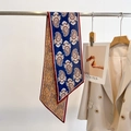 Classic paisley silk scarf with dual-sided design on metal rod next to a blazer - Navy Blue