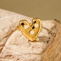 Gold heart-shaped ring with white pearls on a textured stone surface, vintage style - Glossy Heart Pearl Ring (30419-ring-6)