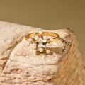 Star-shaped golden ring featuring a faceted crystal center and delicate pearl accents - Star Shaped Transparent Gem Ring (30419-ring-11)