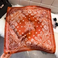 Burnt orange square silk scarf with white paisley patterns on white faux fur background - Orange Red (Paisley Print)