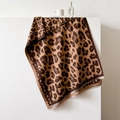 Detail of leopard print scarf featuring thick cashmere-like texture and fringed edges - Caramel color