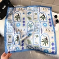 Tropical square silk scarf with toucan and island prints laid on soft white faux fur - Sky Blue (Island Elements)