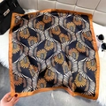 Square silk scarf with orange feather print and black base tied on a designer handbag - Black (Feather Texture)