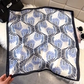 Elegant white square silk scarf with blue and black fan patterns on plush rug - Blue (Feather Abstract)