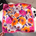 Retro lotus print satin square silk scarf in pink and orange on a white plush background - Rose Pink (Vivid Floral)