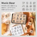 Set di 12 graziosi timbri in legno con orsetto musicale e scatola portaoggetti in metallo - Orso Musicale