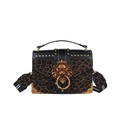 Black leather and leopard print handbag featuring a bronze lion head and gold rivets - Green