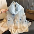 Light blue faux silk scarf featuring floral embroidery and gold edge trim on white sweater - 74.8*27.5inch / Blue