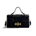 Black snakeskin embossed handbag with a gold-tone M-shaped circular clasp and top handle - Black