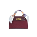 Detail of burgundy Kelly style bag featuring gold twist lock and silk scarf handle wrap - Burgundy