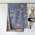Detail view of maple leaf jacquard pattern on elegant blue-grey pashmina with fringe edge - Blue