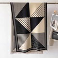 Detail of a minimalist geometric plaid scarf with premium knit texture and fringe trim - Black