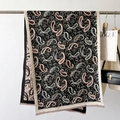 Detail of vintage paisley pattern on soft black shawl with delicate fringe and floral motifs - Black