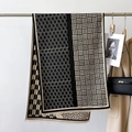 Detail showing high-end black and beige jacquard scarf with geometric knit texture - 66*186cm / Black