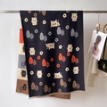 Detail of navy blue cashmere-feel scarf showing cartoon cat patterns and short tassels - Black