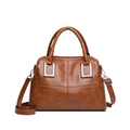 Retro brown faux leather tote bag with crossbody strap and silver hardware on white background - Yellow Brown
