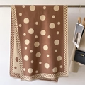 Detail of coffee brown polka dot scarf featuring frayed edges and soft texture - Khaki