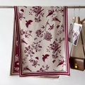 Detail of floral bird print scarf with fringe edges and thick cashmere-like texture - Red