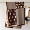 Detail of bicolor scarf with houndstooth pattern and cat print with fringe trim - Coffee
