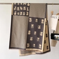 Detail of winter scarf featuring houndstooth pattern and cartoon cat prints with tassels - Gray