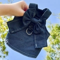 Detail of dark blue denim dog harness featuring a large bow and silver D-ring - Style 303 Cyan Denim Vest