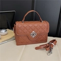 Brown quilted crossbody bag with silver floral lock and adjustable shoulder strap - Brown