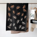 Detail of leaf jacquard knit shawl with thick texture and frayed edges on a rack - Black