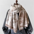 Macro detail of the bamboo leaf print texture and soft fringes on the latte scarf - Khaki