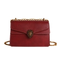 Deep red crossbody bag featuring litchi grain leather and a golden lion head clasp - Red
