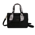 Black pebble leather handbag with geometric silk scarf wrap on the handle and gold lettering - Black
