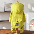 Detail view of the waterproof dog jumpsuit with a hood and PRAISE mountain logo - S / Bright Yellow
