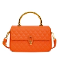 Chic orange quilted crossbody bag with a gold bamboo-style handle and metal lock - Orange