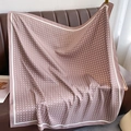 Silk-like polka dot shawl scarf in dusty rose pink draped on a leather sofa - Dusty Pink