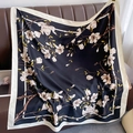 Close-up of vintage floral silk scarf with magnolia print and satin texture on leather - 90*90cm / Black