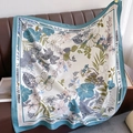 Elegant floral square scarf with blue border and animal print draped on a leather sofa - 90*90cm / Light Blue