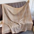 Classic brown houndstooth silk-like square scarf draped over a leather sofa backdrop - Khaki Houndstooth (XW-35-Khaki)
